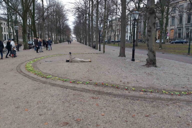 Philemon Mukarno Performance Art War flowers (2018)2h The Embodiment of Time Festival, Het Lange Voorhout, The Hague, Netherlands.