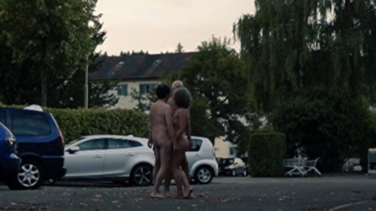 Naked performance in the public space by Philemon Mukarno, Thomas Zollinger, Susanne Guggisberg.