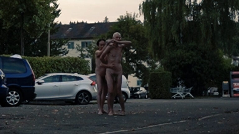 Naked performance in the public space by Philemon Mukarno, Thomas Zollinger, Susanne Guggisberg.