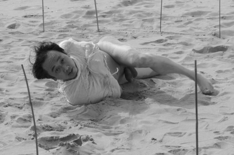 Philemon Mukarno performing naked at the Scheveningen beach in the Netherlands