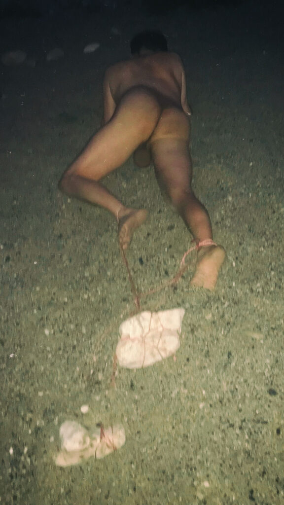 nude man Dragging Stones
