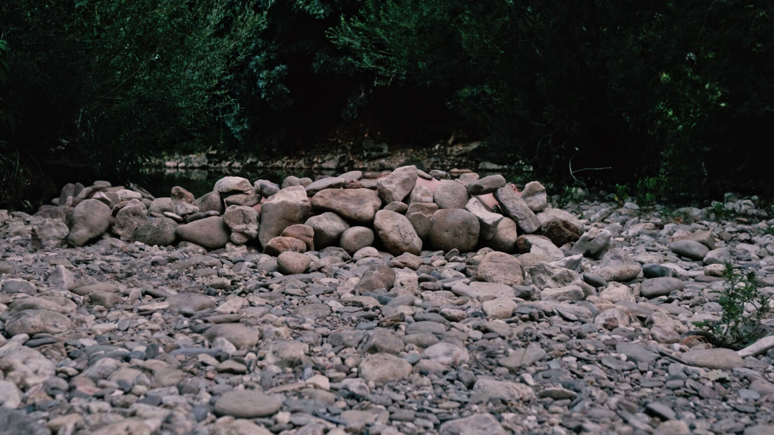 Philemon Mukarno lying naked on stones