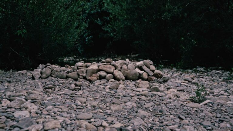 Philemon Mukarno lying naked on stones