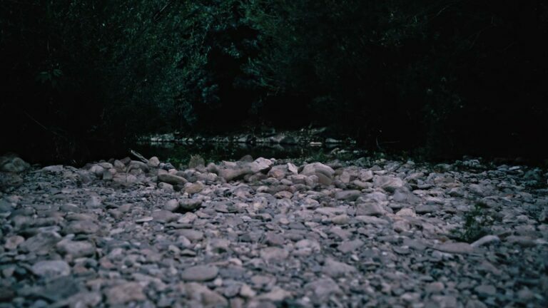 Philemon Mukarno lying naked on stones