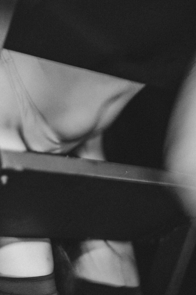 Abstract black and white photo with blurred naked figure lying down