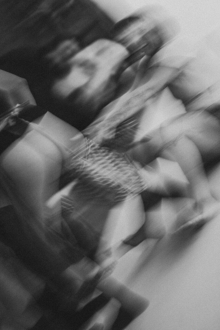 Blurred motion image of two naked performers in an intense physical embrace