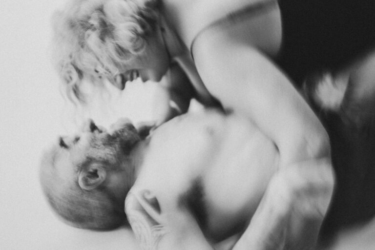 Artistic black and white image of two naked performers in an intimate pose